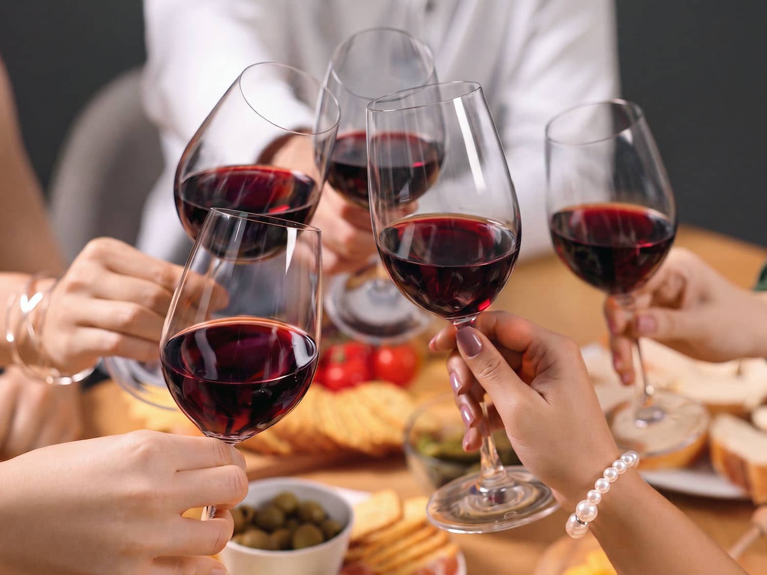 Hands holding wine glasses