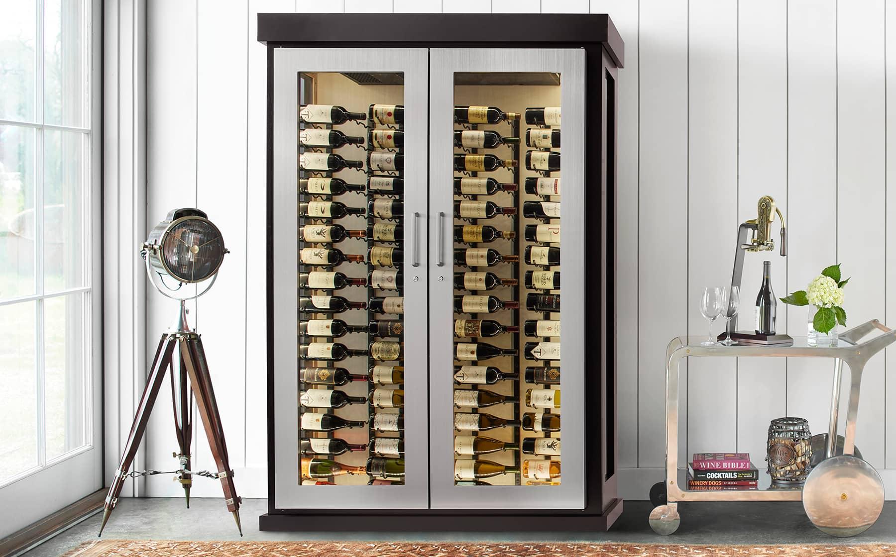 Dramatic stainless steel edged custom glass enclosed wine cabinet.