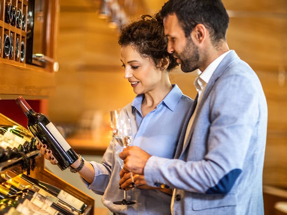 People In Wine Cellar Choosing Bottle