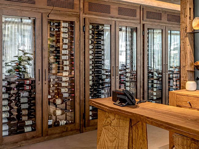 Cozy wood framed wine cabinets with glass doors.
