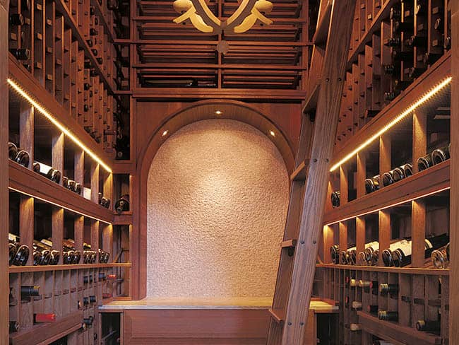 Closet transformed into a wine room with elegant archway.