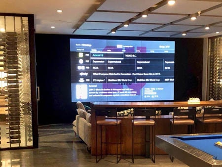 Entertainment center with large glass wine cellars.
