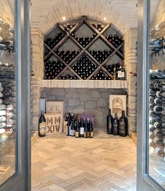 Custom wine cellar with stone walls.