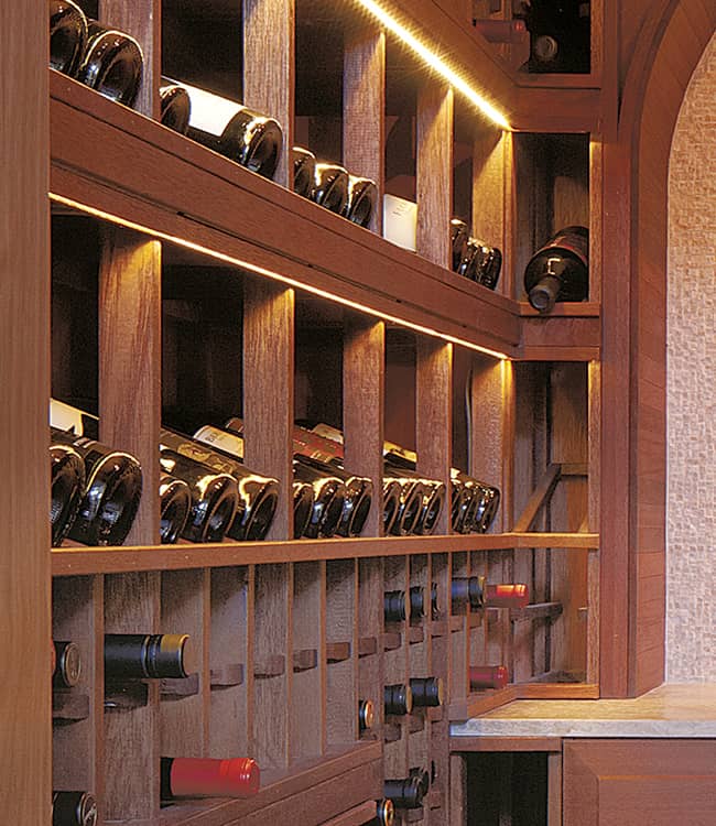 Custom wine room with wood wine racks and decorative archway.