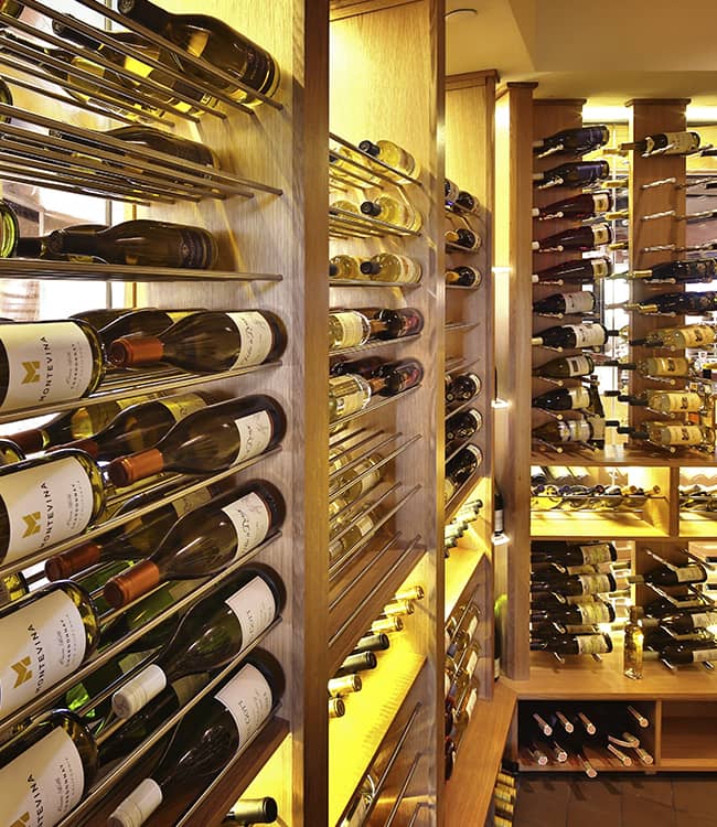 Metal wine racks displaying wine bottles