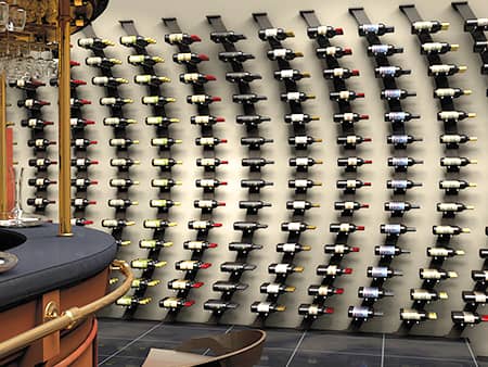 Showcase wine display floating on a wall in dramatic curves.