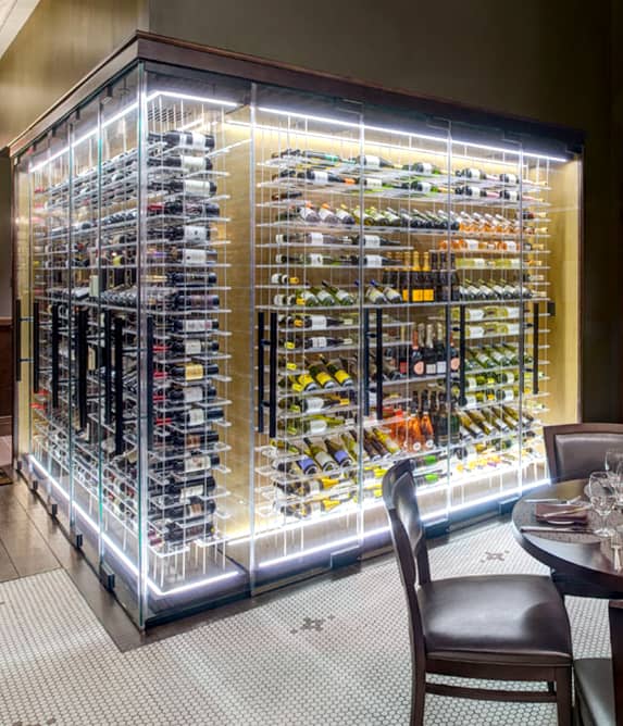 Elegant wine cellar surrounded by glass walls.